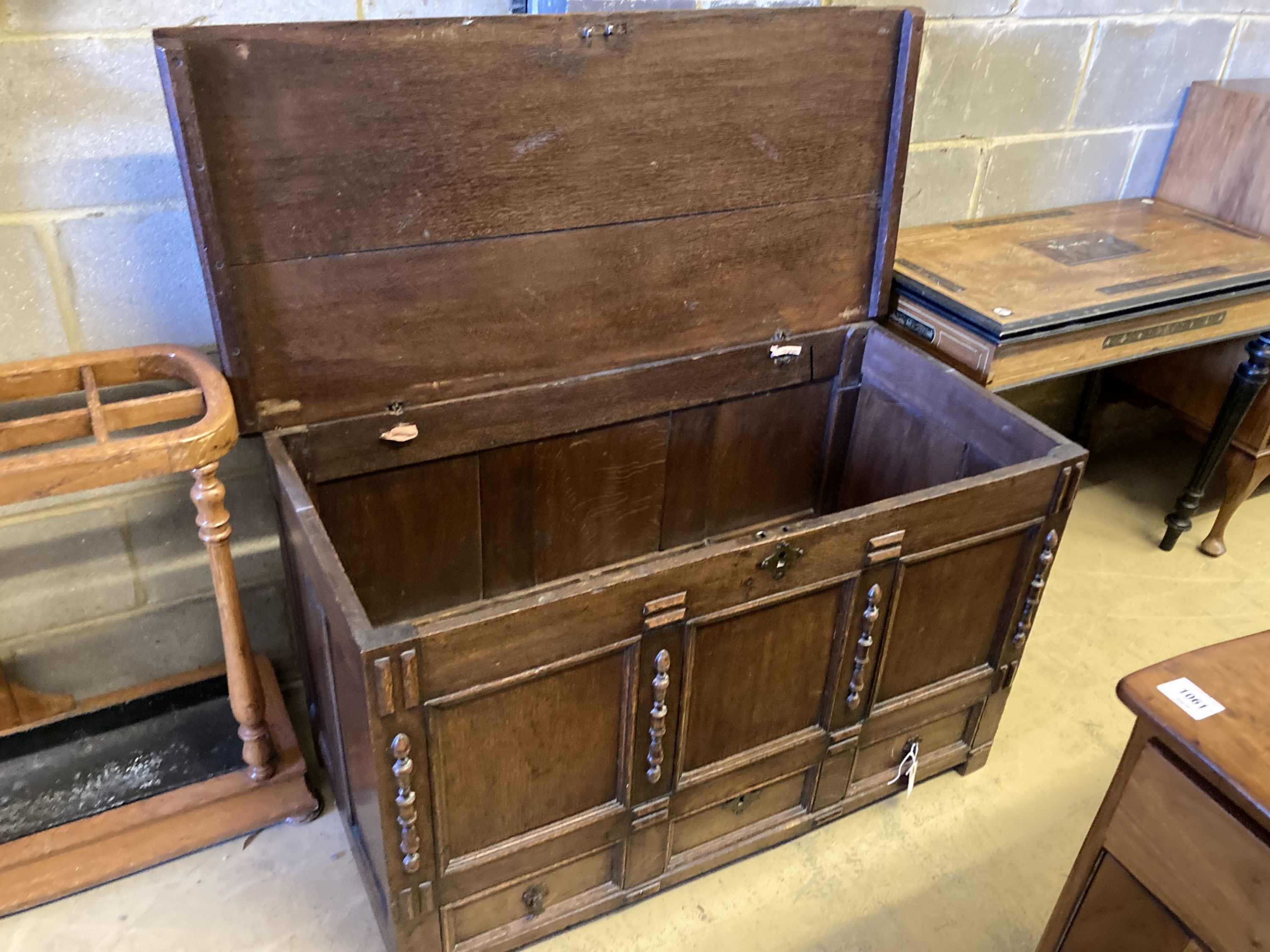 An 18th century panelled oak mule chest with planked top, length 118cm, depth 55cm, height 68cm